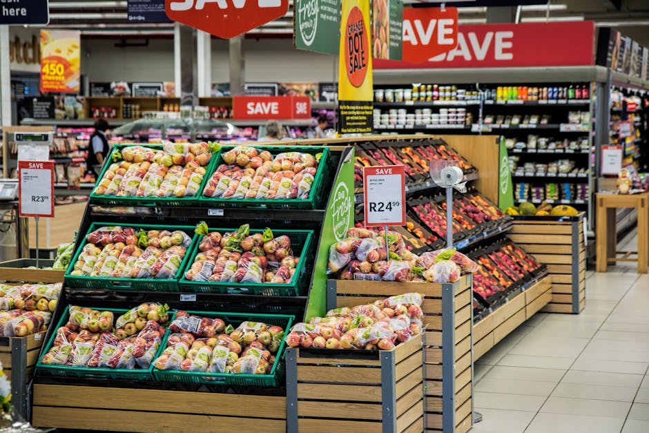 IAM Retail Colorful produce aisle in a supermarket showcasing fresh apples with discount signage.